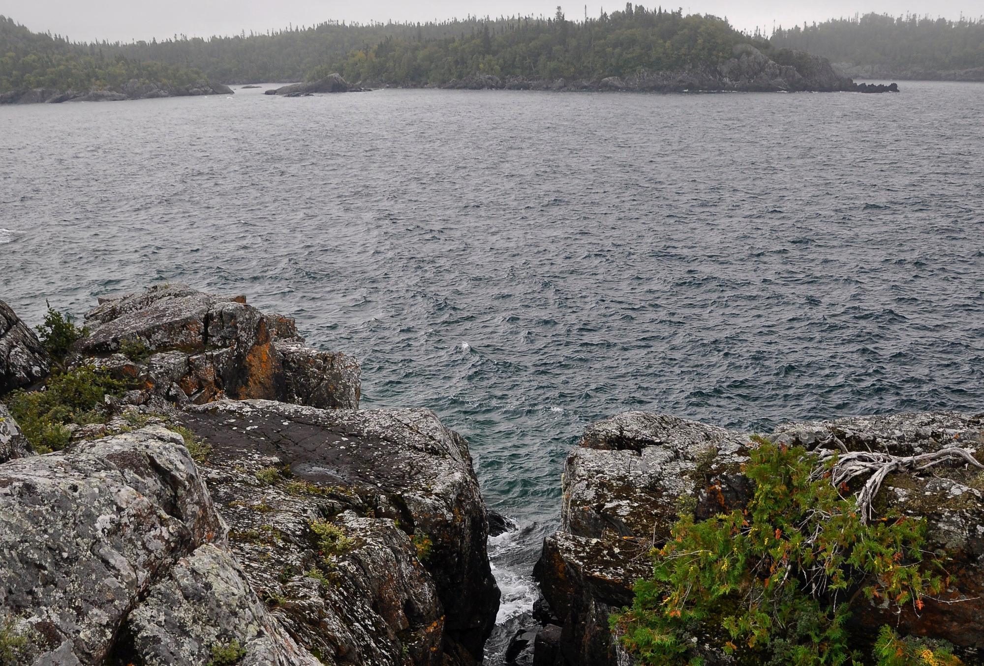 Weathered rock shoreline over the cold open water of Lake Superior, Ontario